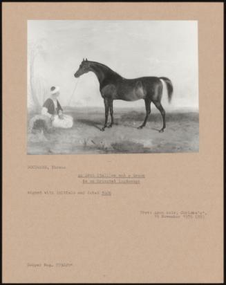 An Arab Stallion and a Groom in an Oriental Landscape