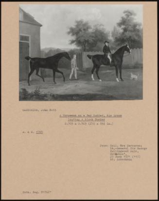 A Horseman on a Bay Hunter, His Groom Leading a Black Hunter