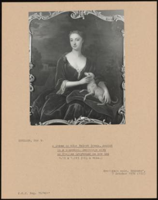 A Woman In A Blue Velvet Dress, Seated In A Classical Landscape With An Italian Greyhound On Her Lap