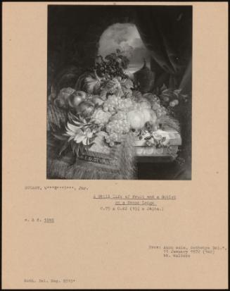 A Still Life of Fruit and a Goblet on a Stone Ledge