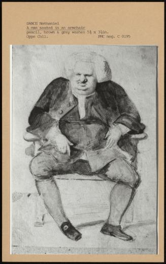 A Man Seated In An Armchair