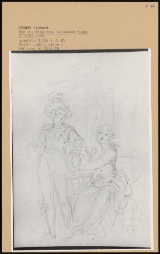 Man Standing Next To Seated Woman