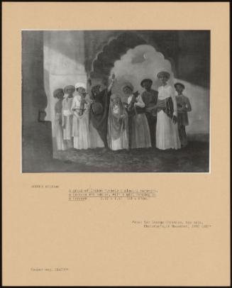 A Group Of Indian Musicians Playing Saranghi, A Tambura And Tables, With A Girl Dancing On A Terrace