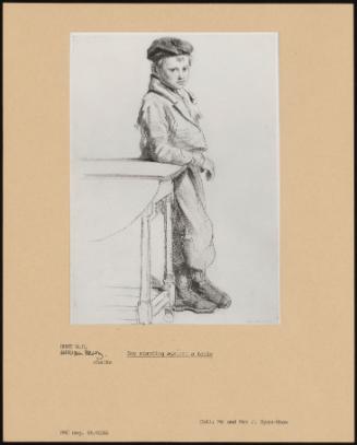 Boy Standing Against A Table